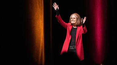 Gloria Steinem enters the Northop stage for the Distiguished Carlson Lecture