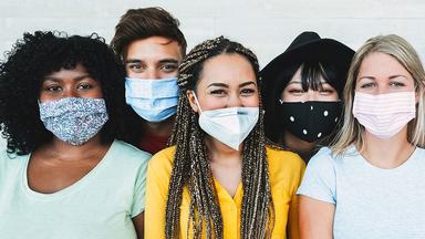 A group of young adults wearing facemasks