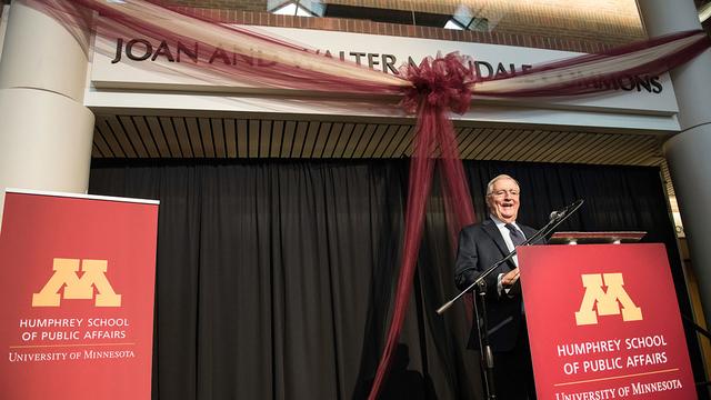 Walter Mondale stands behind a podium and speaks in the Joan and Walter Mondale Commons