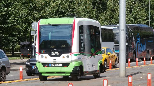 A driverless bus on a busy street