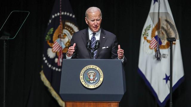 President Joe Biden standing behind a podium, speaking 