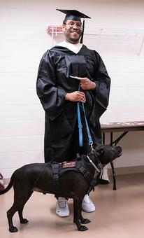 MPA graduate Corey Dawson and his dog Oscar backstage at 2022 commencement ceremony