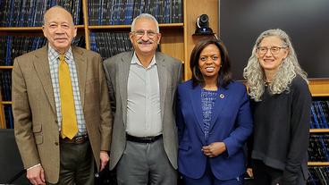 Sanda Ojiambo photo with Humphrey School faculty members Samuel Myers Jr., Ragui Assaad, and Deborah Levison
